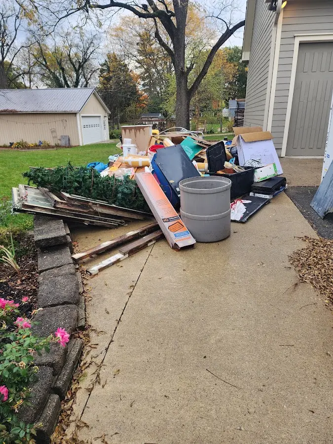 Dumpster being loaded with debris for Estate Cleanout Dumpster Rental in White Oak